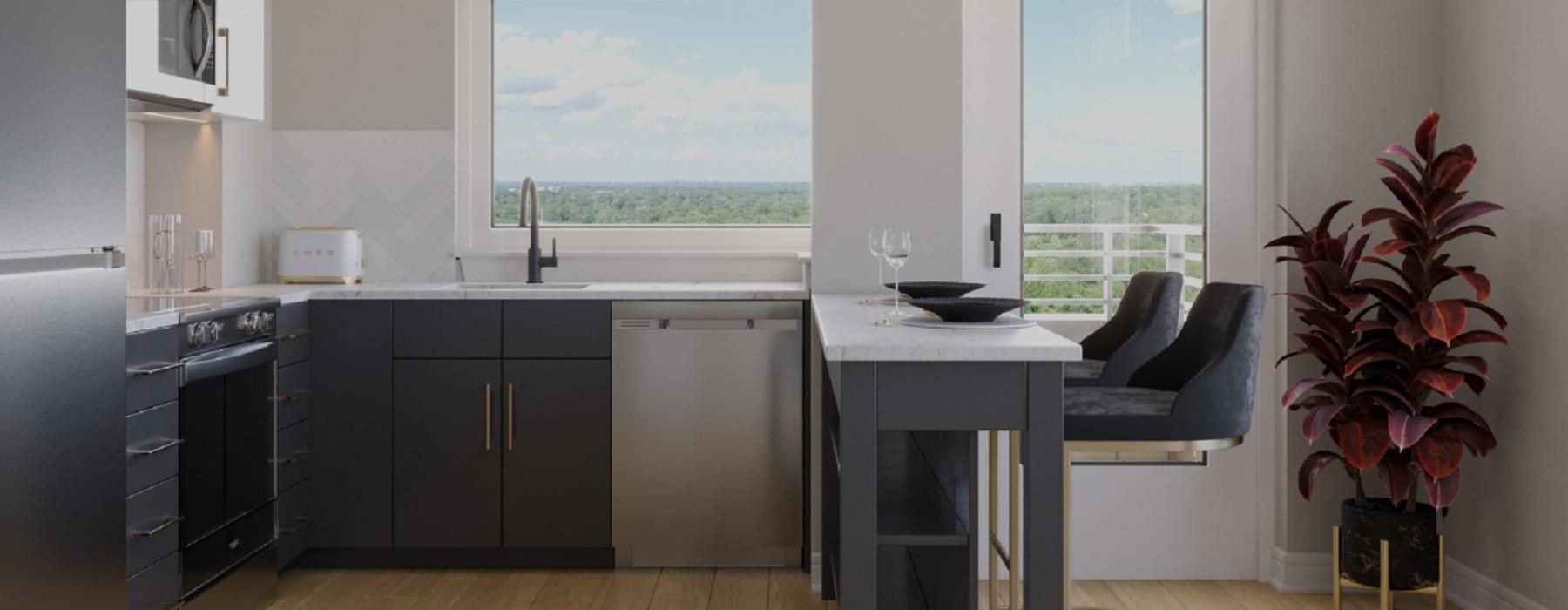 Model kitchen at our apartments for rent in Bethesda, MD, featuring wood grain floor paneling and stainless steel appliances.